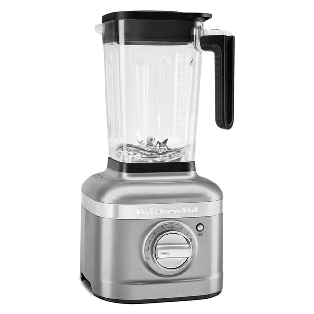 KitchenAid K400 Blender with a clear ribbed jar and black handle on a silver base featuring a variable speed dial from 0 to 5 and preset program icons, ideal for countertop blending of tough ingredients like kale and almonds, also suitable for making smoothies and icy drinks.