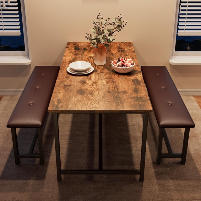 BeesClover Dining Table with 2 Benches, a rectangular dining room table set for 4, featuring a wood-grain finish and two upholstered benches with button-tufted PU surfaces. The table has a sturdy metal frame with an H-shaped base for stability, and the benches tuck neatly underneath for space-saving convenience. Ideal for apartments, kitchens, or dining rooms, this 44.5-inch table set is shown in a cozy dining area with a vase, plates, and fruit bowl on the table.