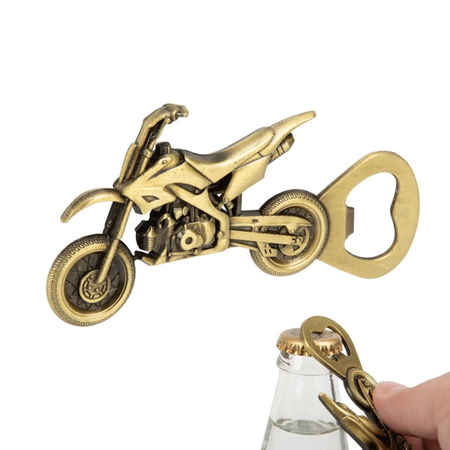 Perfect Solutions Dirt Bike-Shaped Bottle Opener in antique brass finish with detailed motorcycle design and textured tires, shown in a close-up front angle. This sturdy, travel-sized bar tool effortlessly opens capped glass bottles and is easy to store for picnics or parties.