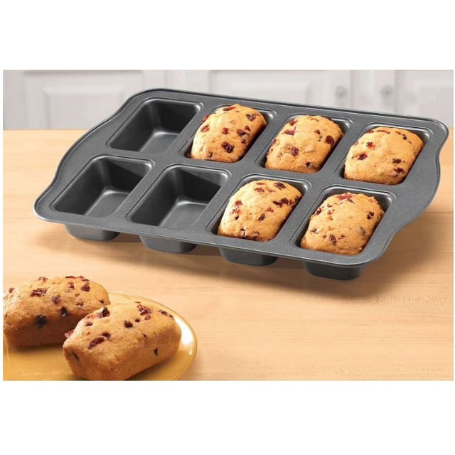 Mini Loaf Baking Pans Non-Stick Mini Loaf Baking Pan with 8 wells, displayed with freshly baked mini loaves featuring cranberry toppings. The pan is crafted from durable non-stick metal, measuring 9 ½” x 13” overall, with each loaf compartment measuring 2 ½” x 3 ¾”. Perfect for baking sweet breads, mini meat loaves, casseroles, and meal prep. Also suitable for creating homemade gifts like fruitcakes or quiches.