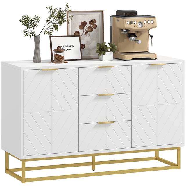 HOMCOM 3-Drawer Storage Cabinet Sideboard for Dining Room, Living Room. This white sideboard features three central drawers and two cabinets with geometric lined doors, accented by golden handles and a matching golden base. The elevated base design protects against moisture, while adjustable shelves inside the cabinets provide customizable storage. Made of durable MDF and metal, it is suitable for storing kitchen supplies, coffee bar utensils, or other essentials. The top surface is styled with decor items and a coffee machine.