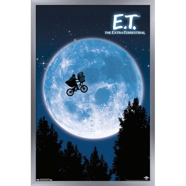 E.T. The Extra-Terrestrial Wall Poster, 22.375" x 34", shows a silhouette of a boy on a bicycle carrying an alien in the basket flying in front of a large blue moon with stars in the night sky and tree silhouettes below, printed on glossy paper by Trends International, suitable for bedroom or office wall decor.