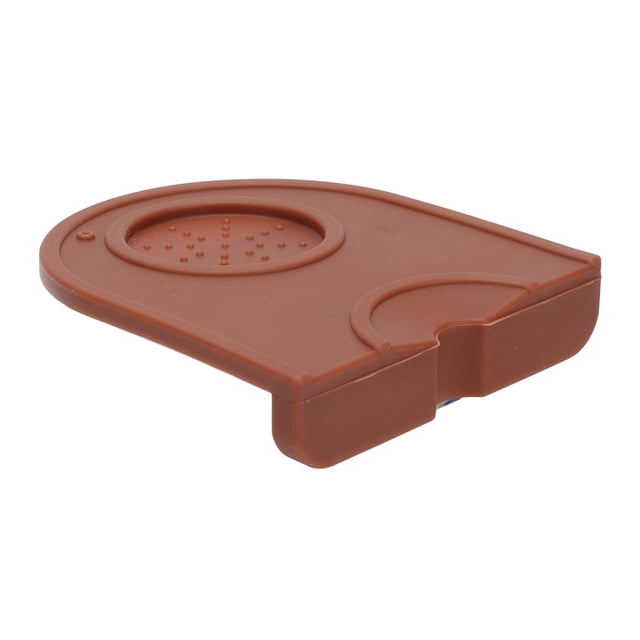 Coffee Tamper Pad, Anti Slip Soft Compact Coffee Tamping Mat made of durable, heat-resistant silicone material in a brown finish. Features a compact size of approximately 12.5 x 14 cm (4.9 x 5.5 in) and includes a raised circular tamping area and a notch for edge placement. Ideal for protecting work surfaces in kitchens or restaurants.