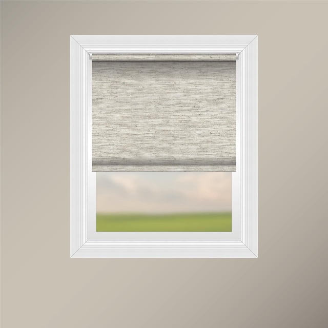 Off Cut Shades Chainless Woven Roller Shade in beige woven polyester fabric with a plain hem and weighted insert, mounted inside a white window frame with a sturdy white aluminum headrail, partially lowered to softly filter light and ensure privacy while showing a blurred outdoor view.