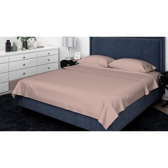 Johnson Home 600 Thread Egyptian Count Cotton Sheet Set on a king-size bed with navy blue upholstered headboard and silver nailhead trim, featuring beige 600 thread count Egyptian cotton sheets and pillowcases, in a modern bedroom with white dresser, decorative vases, and glass lamp, highlighting breathable, all-season cotton fabric with extra deep 15-inch fitted sheet pockets.