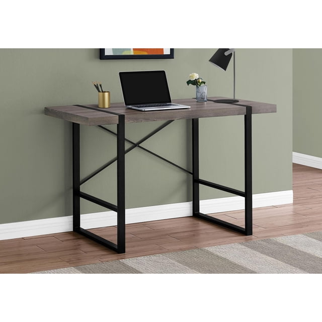 Monarch Specialties Computer Desk, Home Office, Laptop, 48"l, Work, Metal, Laminate, Brown, Black, Contemporary, Modern. A front-facing view of a compact desk with a thick dark taupe laminate wood-look top supported by black metal tube legs and an X crossbar frame. The desk holds a laptop, black desk lamp, small plant in a glass vase, and gold pencil holder with pencils. Ideal for small spaces and versatile home office setups.