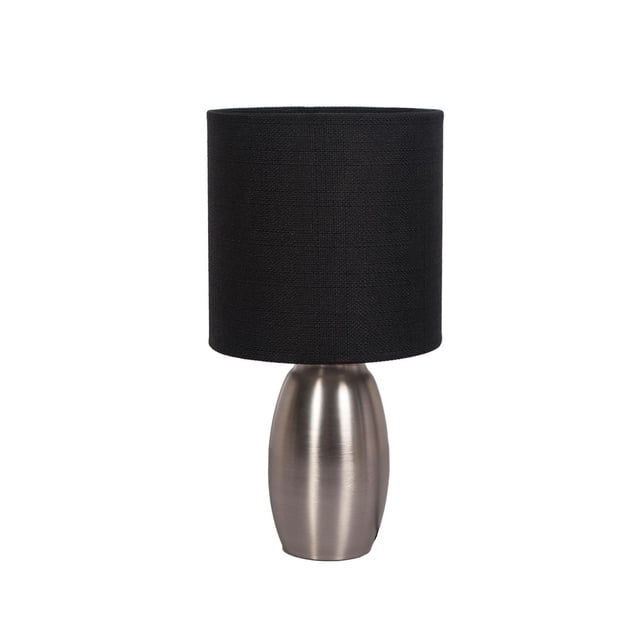 HOMETRENDS Accent Lamp with a dark pewter plated steel base in a smooth oval shape and a textured black fabric cylindrical shade measuring 5.6 inches diameter by 6 inches high, standing 11.5 inches tall, featuring a push-through on/off switch, suitable for lighting desks or bedside tables in home or office settings.