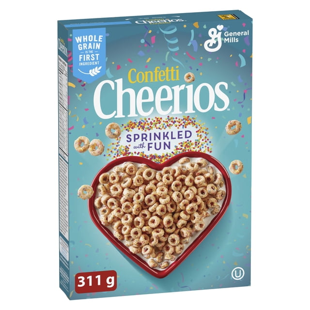 Confetti Cheerios Cereal 311 g box showing vanilla-flavored whole grain oat Os with colorful sprinkles in a heart-shaped bowl on a blue confetti background, highlighting no artificial colours or flavours and whole grain as the first ingredient, ideal for breakfast or snacks.