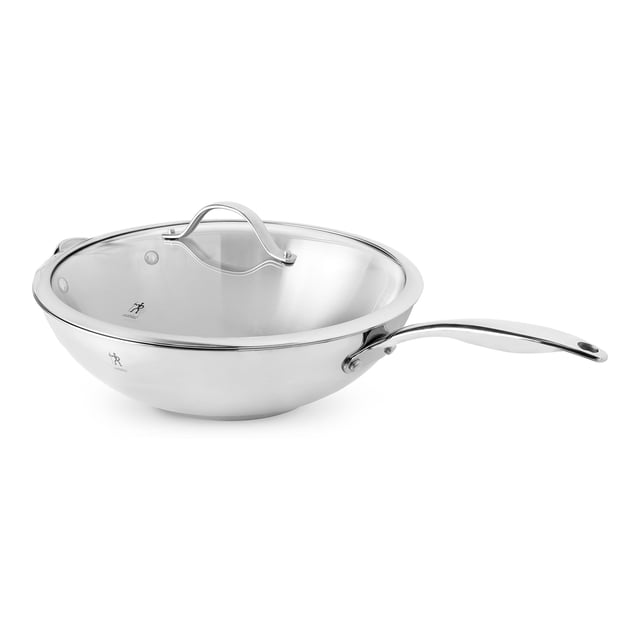 HENCKELS Aragon 32 cm / 12.5 inch stainless steel wok with a polished mirror finish and tempered glass lid. Features ergonomic stay-cool handles and a tri-ply encapsulated base for even heating. Suitable for searing, sautéing, steaming, and stir frying. Compatible with all stovetops, including induction, and oven safe up to 500°F.