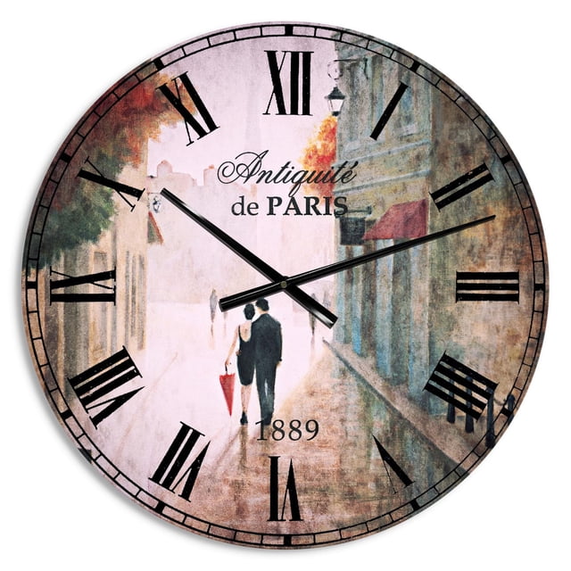 Designart 'Paris Romance Couples II' Traditional wall clock with a glossy 100% aluminum round face featuring a Paris street scene of a couple walking with a red umbrella. It has black Roman numerals, black hands, and printed text 'Antiquité de Paris' and '1889'. Ready to hang, ideal for home or office décor.
