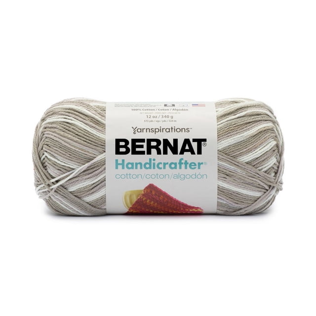 Bernat® Handicrafter® Ombre Yarn, Cotton #4 Medium, 12oz/340g, 573 yards, skein in neutral beige and white tones with soft cotton texture, wrapped with a white label showing brand and product details. This worsted weight yarn is machine washable and ideal for knitting and crochet home decor projects.