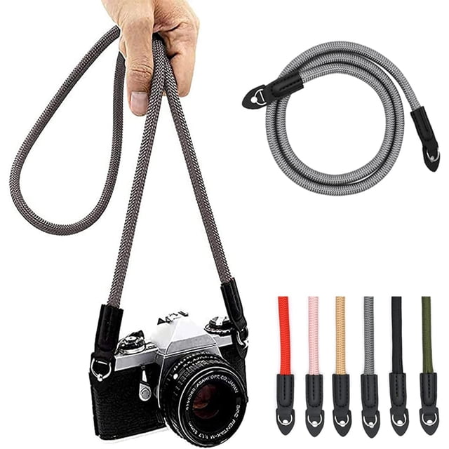 LAICAIW Camera Strap Vintage 100cm Nylon Climbing Rope Camera Neck Shoulder Strap for Micro Single and DSLR Camera. The strap is made of durable 10mm diameter nylon climbing rope, offering flexibility and strength. It features a minimalist design suitable for various camera types, including retro, mirrorless, and full-frame DSLR cameras. The strap is shown in a grey colour, with options for other colours visible. It can be worn around the neck, over the shoulder, or on the wrist, providing versatile carrying options. Includes universal mounting with connecting rings for secure attachment.