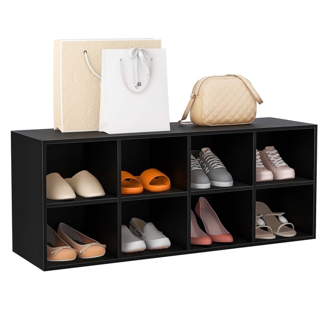 Costway Shoe Bench 8 Cubbies Shoe Organizer with 500 LBS Weight Capacity Cubby Shoe Rack in black. The bench features eight compartments, each holding various types of shoes, including sneakers, slippers, and high heels. The top surface is spacious and sturdy, supporting up to 500 lbs, and is shown with shopping bags and a beige handbag placed on it. Made of engineered wood, the bench includes anti-slip foot pads for stability and adhesive screw stickers for a polished look. Ideal for entryways, bedrooms, or living rooms.
