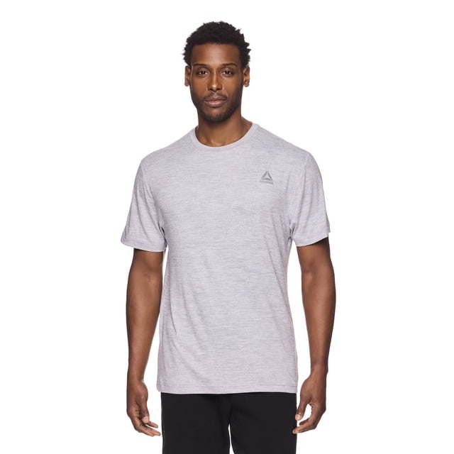 Reebok Men's Delta Core Short Sleeve Tee in light grey heather with a crew neck and short sleeves, made from soft, moisture-wicking polyester-spandex jersey fabric. It features a fitted upper torso and relaxed midsection fit with a small Reebok Delta logo on the left chest, ideal for workouts or casual wear.
