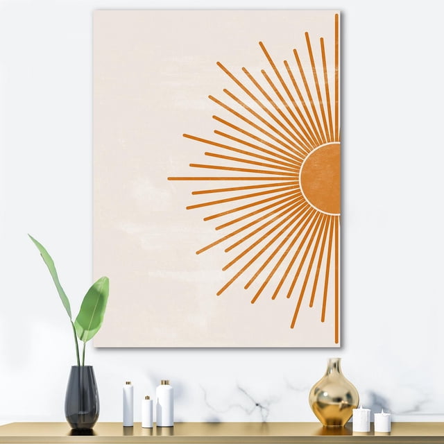Designart Orange Sun Print I Canvas Wall Art showing a modern geometric orange sunburst design on a light beige textured background, gallery-wrapped on premium cotton canvas and ready to hang, displayed above a minimalist console with decorative vases and candles, ideal for contemporary home décor.
