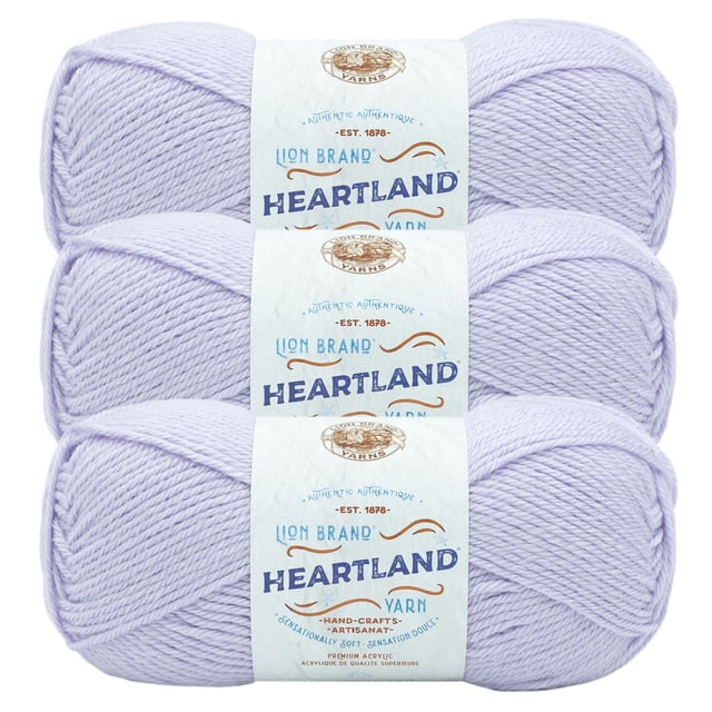 Lion Brand Yarn Heartland Yarn 3Pack with three skeins of light lavender worsted weight acrylic yarn, each wrapped in a white label featuring the brand and product name, suitable for knitting, crochet, and crafting durable projects.