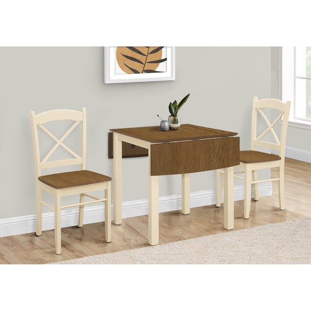 Monarch Specialties I 1327 dining table with a 48-inch rectangular oak veneer top and cream-colored solid wood legs. The table features two drop leaves, allowing it to seat up to 4 people when extended or 2 when folded down. Shown in a casual dining room setting with matching cream and oak chairs (sold separately). Ideal for small kitchens or dining spaces, with a transitional style and easy assembly.