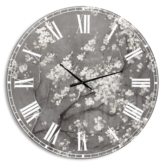 Designart 'White Cherry Blossoms I' Traditional wall clock with a round solid aluminum frame and glossy grey background featuring white cherry blossom branches. It displays white Roman numerals and black hands, suitable as a modern oversized wall décor piece.