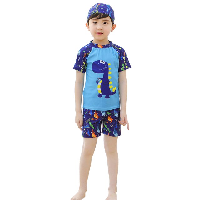 EDTara Kids Boys Short Sleeve Rashguard Swim Shirt and Trunks Bathing Suit with Swimming Cap. This boys' swimwear set includes a blue short-sleeve rashguard with a cartoon dinosaur print, matching swim trunks with a colourful dinosaur pattern, and a coordinating swim cap. Made of 80% polyester, it is lightweight, fast-drying, and elastic, perfect for boys aged 3-13 years. Suitable for swimming, beach outings, and water activities.