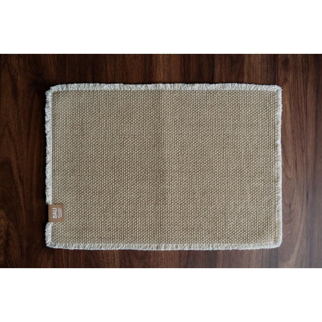 Fabstyles 100% Cotton Bali Placemats set of 4 includes a rectangular beige placemat with a textured woven cotton surface and white fringed edges, measuring 14 by 20 inches, shown on a dark wood table, ideal for dining, kitchen, and outdoor table linens.