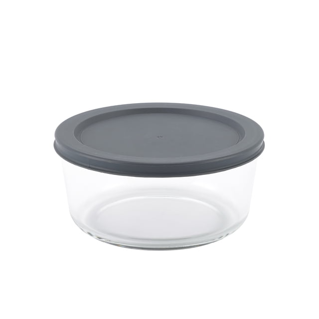 Mainstays Round Glass Food Storage Container with PE Lid 920ml, clear borosilicate glass container with a dark grey PE lid, BPA-free and FDA approved, oven, microwave, freezer, and dishwasher safe, suitable for storing and reheating food, also often used for organizing small kitchen items.