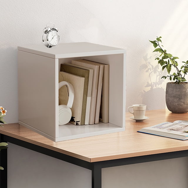 Ycandiee Cube Storage Organizer, a stackable and versatile cube storage unit made of eco-friendly melamine board, shown in a minimalist home setting. The cube is placed on a wooden desk and contains books and headphones, with a clock on top. Ideal for organizing books, clothes, or toys.