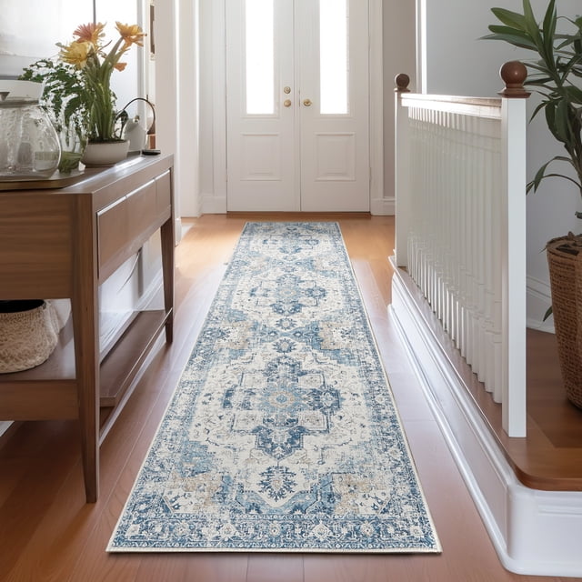 RUGKING Vintage Runner Rug 2x7 Blue with a distressed medallion design placed in a bright entryway hallway. The thin, non-slip rug features a vintage floral pattern in shades of blue and beige, complementing the wooden flooring and surrounding decor. Suitable for kitchens, bathrooms, or bedrooms.
