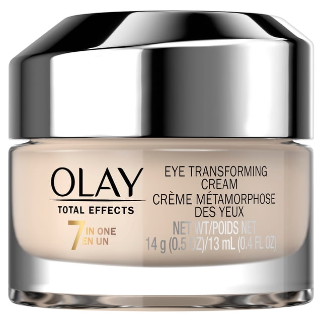 Olay Total Effects Transforming Eye Cream in a clear glass jar with a reflective silver lid, containing 14 g (0.5 oz) or 13 mL (0.4 fl oz) of fast-absorbing eye moisturizer with a 7-in-1 formula that hydrates, smooths fine lines, brightens, and nourishes delicate skin around the eyes.