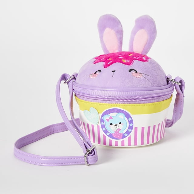 Claire's Bunny Cupcake Shoulder Bag in purple, featuring a whimsical design with a bunny face, fluffy ears, and a cupcake motif. The bag has a compact round shape with a pink frosted top, striped base, and a purple adjustable shoulder strap. Ideal for kids' accessories or carrying small essentials.