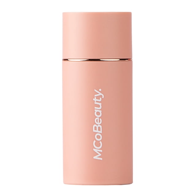MCoBeauty Baby Face Multi-Use Cream Stick in a matte peach cylindrical container with white logo, a hydrating, buildable cream blush stick for cheeks and lips providing a natural radiant glow.
