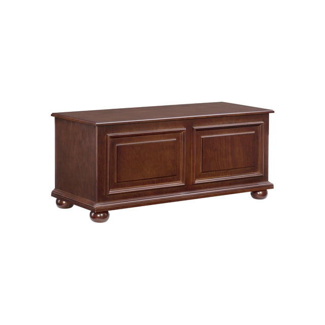 Lorcan Cedar Chest, Cherry, a rectangular wooden storage chest with a rich cherry brown finish, raised panel doors, decorative molding, and bun feet, featuring a cedar-lined interior with child-safe hinges and breath holes, suitable for storing fabric items and adding seating to any room.