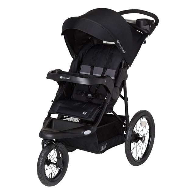 Baby Trend XCEL-R8 PLUS Jogger with LED Safety Light, black three-wheeled all-terrain stroller with adjustable canopy and peek-a-boo window, reclining seat with 5-point harness, child’s swing-away tray, large storage basket, and parent console with cup holders, shown in 3/4 front view.