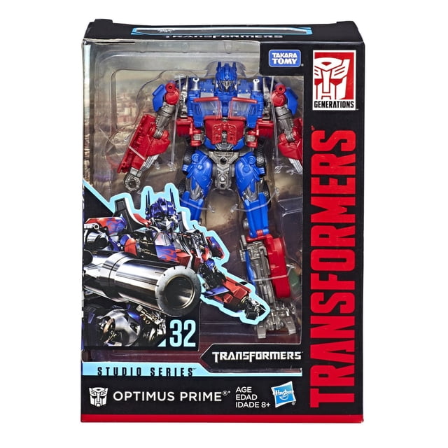 Transformers Studio Series 32 Voyager Class Movie 1 Optimus Prime Action Figure in original packaging, featuring a 6.5-inch robot figure in red, blue, and silver with detailed mechanical design, posed in robot mode with removable backdrop and blaster weapon accessory, suitable for TV and movie action figure collectors aged 8 and up.