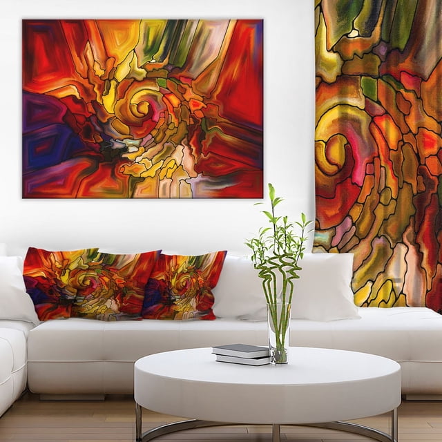 Gutermann Design Art Illusions of Stained Glass Canvas Print featuring an abstract spiral pattern in red, orange, yellow, green, and purple tones, gallery wrapped on a 1-inch wood sub frame, ready to hang above a white sectional sofa with matching pillows and a white round coffee table with a glass vase holding green bamboo stalks, suitable for enhancing modern home décor.