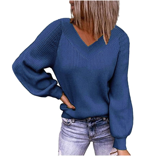 Fall Sweaters for Women V Neck Long Sleeve Solid Color Ribbed Pullover Sweaters. The image shows a casual loose-fit sweater in a solid blue color with a ribbed texture, featuring a V-neckline and long puffed sleeves. The sweater is paired with light-wash jeans, highlighting its relaxed and comfy style.