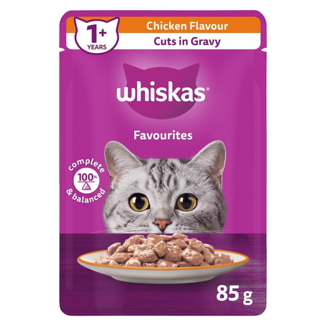 WHISKAS FAVOURITES Cuts in Gravy Chicken Flavour Pouch Adult Wet Cat Food shows an 85g purple pouch with a gray tabby cat's face above a plate of chicken-flavored wet cat food cuts in gravy, designed for adult cats 1+ years, offering 100% complete and balanced nutrition with vitamin E and no artificial preservatives.