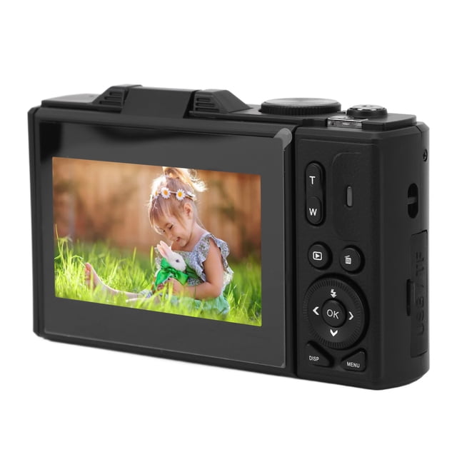 4K Digital Camera with 3 Inch Flip Screen for Photography and Vlogging, featuring 18X zoom, autofocus, and UHD 4K video recording. The camera has a 64MP resolution and doubles as a webcam for travel photography and vlogging. The image shows the rear view of the camera with its IPS screen displaying a vibrant photo of a child sitting outdoors. Buttons for zoom, menu, and navigation are visible on the side.