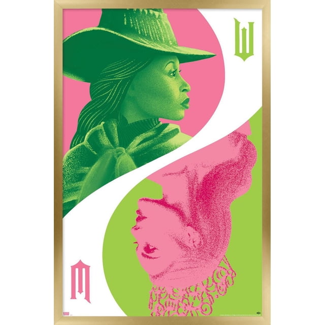 Wicked - Reflection Wall Poster with Push Pins, 22.375" x 34" features two stylized female profiles arranged in a yin-yang pattern. The top profile is green with a wide-brimmed hat and flowing hair on a pink background, while the bottom profile is pink with a detailed crown on a green background. A white curved divider separates the images, accented by gothic letters 'W' and 'M' in green and pink. Printed on glossy paper with a light wood frame, ideal for bedroom or office wall decor.