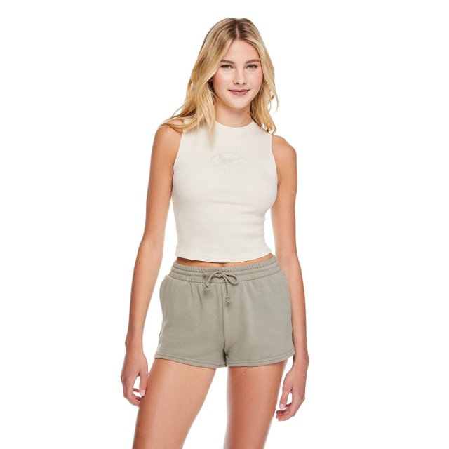 No Boundaries women's rib tank top in off-white, sleeveless with a crew neckline and fitted rib knit cotton blend fabric, styled with light grey drawstring shorts, shown front-facing on a model against a white background, suitable for casual wear or layering.