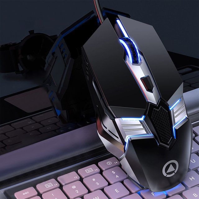 Styesk Mouse Carving G12 Wired USB Luminous Mouse Game Macro Programming Computer Accessory. A black ergonomic gaming mouse with a futuristic spaceship-style design, featuring six buttons, frosted ABS material, and a colourful seven-colour backlight effect. The mouse is shown on a keyboard, highlighting its luminous accents and electroplated tail wing compartment. It includes a 127cm wired connection and supports four-speed DPI adjustment for versatile use in office or esports settings.