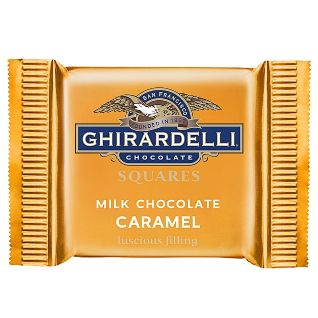 Ghirardelli Individually-Wrapped Milk Chocolate Caramel Squares - 430/Case. A close-up of a golden wrapper showcasing the Ghirardelli logo and text highlighting milk chocolate with caramel filling. Perfect for restaurants, hotels, cafes, or wine tasting rooms as a premium treat.
