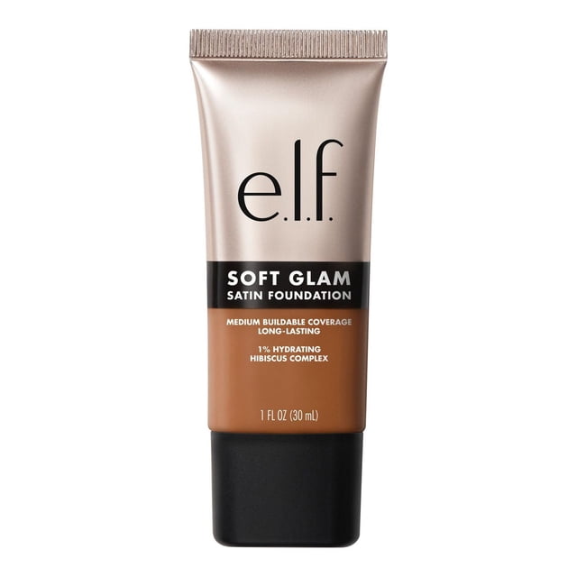 e.l.f. Cosmetics Soft Glam Satin Foundation liquid foundation in a 30 ml tube, offering medium buildable coverage with a satin finish and breathable formula infused with 1% hydrating hibiscus complex, shown in a warm medium shade with a matte black cap.