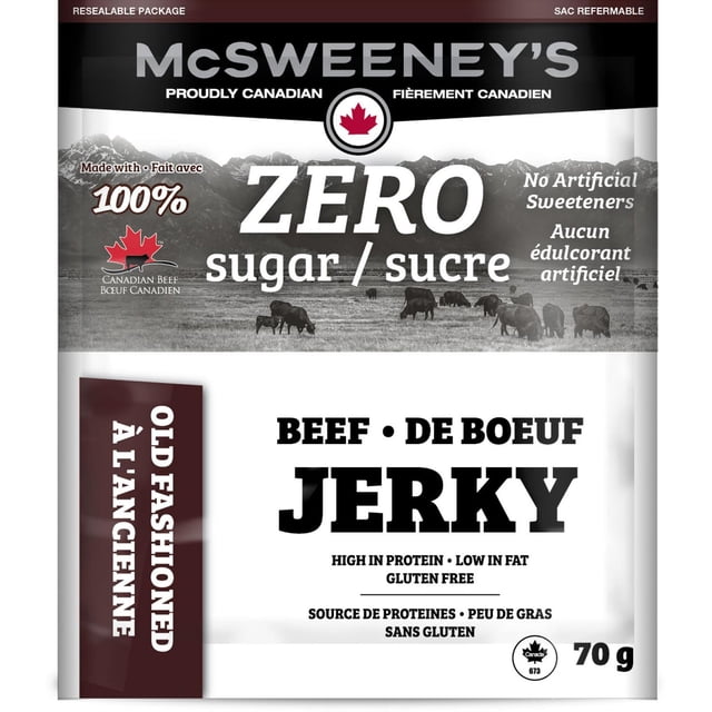 McSweeney's Zero Sugar Old Fashioned Beef Jerky in a resealable 70 g bag made with 100% Canadian beef, naturally smoked, gluten free, and free of artificial sweeteners, shown with a black and white background of grazing cattle and mountains.
