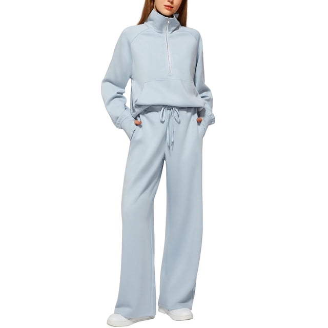 Women's Fall Matching Set featuring a half-zip sweatshirt and wide-leg sweatpants in a light blue color. The casual oversized outfit is designed for comfort and style, suitable for various activities such as lounging, exercise, or travel. The sweatshirt includes a high collar and kangaroo pocket, while the pants feature a drawstring waist for an adjustable fit. Made from soft, breathable fabric, this two-piece set is versatile and easy to pair with sneakers or boots for a chic, relaxed look.