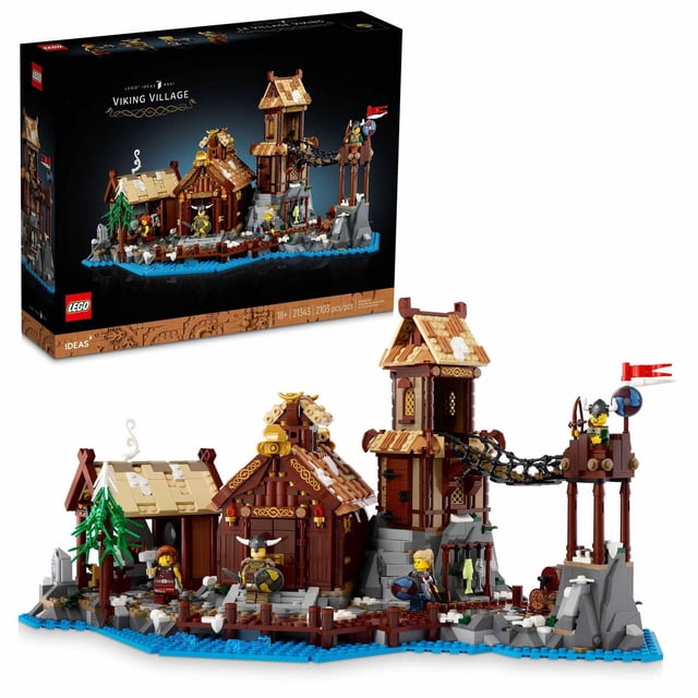 LEGO Ideas Viking Village 21343 Building Set for Adults with 2,103 pieces featuring a detailed Viking Age model including a blacksmith’s smithy, chieftain’s longhouse, and watchtower connected by a rope bridge, with four minifigures equipped with weapons and shields on a rocky shoreline base, suitable for display and historical model building.