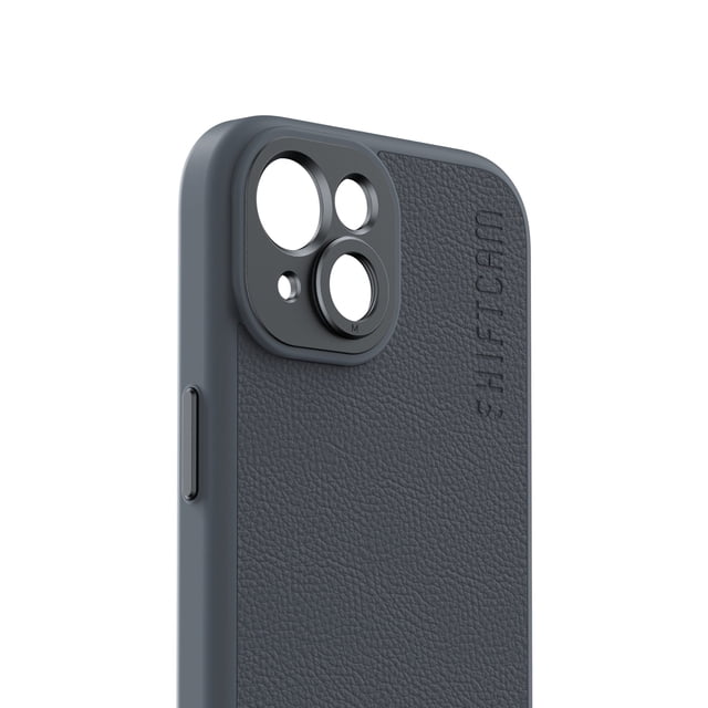 Shiftcam Camera Case for iPhone 15 in a 3/4 profile view featuring dark grey vegan leather with textured grain and embossed Shiftcam logo. It has a built-in matte aluminum lens mount around the camera cutouts for precise alignment and vignetting-free photos, with a durable frame and side button detail.