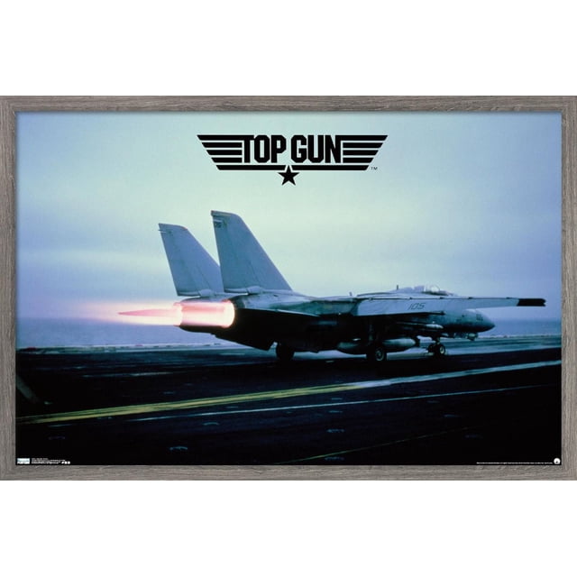 Top Gun - Maverick Plane Wall Poster, 22.375" x 34" showing a side view of a fighter jet with afterburners ignited on an aircraft carrier deck under a cloudy sky, with the black Top Gun logo above the plane, printed on glossy poster paper suitable for wall decor.