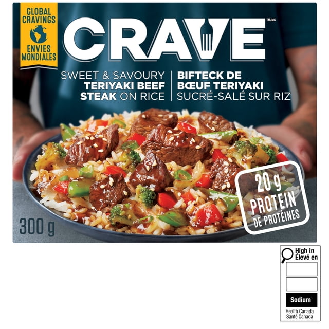 CRAVE Sweet & Savoury Teriyaki Beef Steak on Rice frozen meal 300 g box showing a bowl of fluffy white rice topped with thick teriyaki-glazed beef steak pieces, green onions, sesame seeds, broccoli, and red bell peppers, containing 20 g protein per serving, ideal for quick and easy frozen dinners.