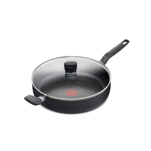 T-fal Essential 5qt/30cm Jumbo Cooker with scratch-resistant non-stick interior and exterior, glass lid with vent hole and black knob, riveted Bakelite handles including a long main handle and short helper handle, and a red Thermo-Spot heat indicator at the center, compatible with all cooktops except induction.