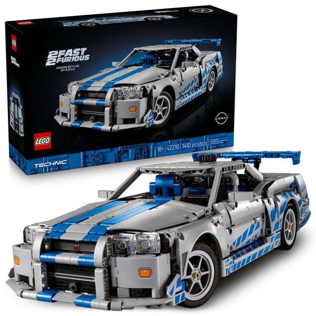 LEGO Technic 2 Fast 2 Furious Nissan Skyline GT-R (R34) Car DIY kit for adults showing a grey and blue model with blue racing stripes, functioning headlights, front grille, large rear spoiler, and realistic 6-cylinder engine, steering, and suspension. The 1,410-piece set includes the box with LEGO, Technic, and Nissan logos, ideal for collectors and model car enthusiasts.